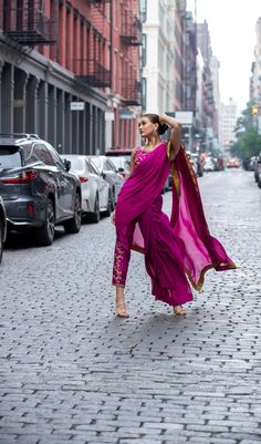 Look bold and elegant in this fusion of Saree Pants adorned with handworked zardozi, resham, dabka, sequins and mukesh to create a perfect symphony! Bright Magenta colored pure chiffon Saree, with a rawsilk blouse and cigarette pants.