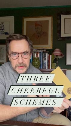 a man holding up three different signs in front of his face with the words, three cheerful schemes