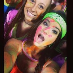 two girls with their faces painted in bright colors