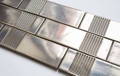 a close up view of some shiny metal tiles