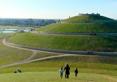 people are walking up and down the hill to see what's in the distance