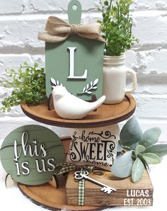 two tiered trays with wooden signs and plants