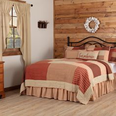 a bed room with a neatly made bed and wooden wall behind the bed is a chest of drawers