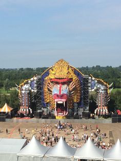 an overhead view of a festival with tents and large animals on the stage in front of them