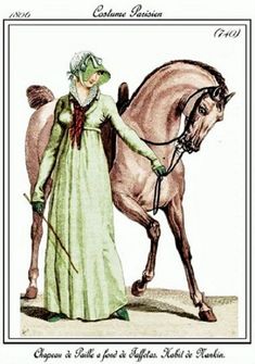 a woman in a green dress is standing next to a horse and holding the reins