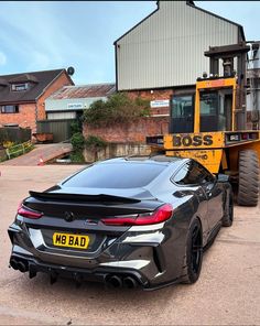 a car parked in front of a construction vehicle