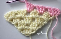 the crochet triangle is being worked on