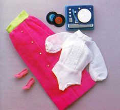 a baby's clothes and accessories laid out on a table