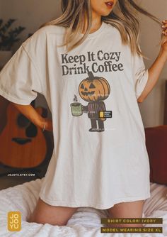 Keep It Cozy, Drink Coffee - Retro Halloween themed Comfort Colors Unisex T-shirt Design by jojoyu. This item is made to order. If you want an oversized fit please size up one or two sizes!  Please note that the colors on the actual shirt might slightly differ from the photos. This is due to different color display on different devices, monitors, as well as the colors of an image may be affected by different lighting conditions. About the shirt: Made from soft, pre-shrunk 100% ringspun cotton, t Cozy Relaxed Fit T-shirt With Graphic Print, Cozy White Graphic Print T-shirt, Cozy Graphic Print T-shirt For Fall, Cozy Cotton T-shirt With Graphic Print, Fall Graphic Tees, Cozy Drinks, Fall Drinks, Drinking Shirts, Coffee Cozy