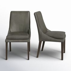 two gray chairs sitting next to each other on a white surface with one chair facing the other