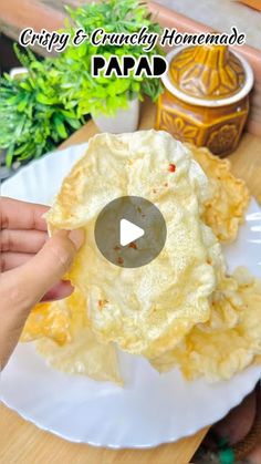 a person is holding up some food on a plate with the words crispy and crunchy homemade paad