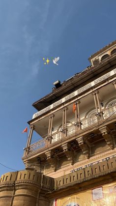 an old building with balcony and balconies on the second floor, under a blue sky