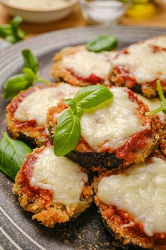 small pizzas with cheese and spinach on a plate