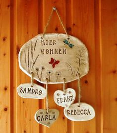 a wooden wall hanging with three ceramic hearts and the words'her women, san francisco de garla '