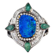 This stunning ring has been meticulously crafted from 18-karat gold and sterling silver. It is centered with 2.46 carats opal, .94 carats emerald and illuminated with .85 carats glittering diamonds. The ring is a size 7 and may be resized to larger or smaller upon request. FOLLOW MEGHNA JEWELS storefront to view the latest collection & exclusive pieces. Meghna Jewels is proudly rated as a Top Seller on 1stDibs with 5 star customer reviews. All items manufactured by us are handmade and can be cus Luxury Green Opal Heirloom Ring, Luxury Heirloom Green Opal Ring, Vintage Opal Diamjnd Emerald Ring, Luxury Green Opal Gemstone Ring, Luxury Green Heirloom Opal Ring, Luxury Green Opal Ring, Luxury Green Opal Ring With Diamond, Luxury Opal Rings With Gemstones, Luxury Opal Rings With Gemstone Accents