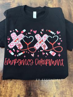 a black t - shirt with pink and red hearts on it that says, emergency department