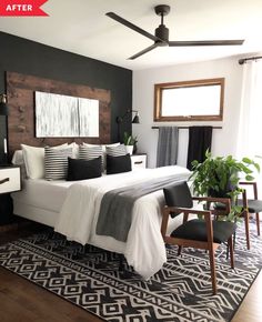 a bedroom with black and white decor, wood headboard