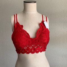 Red Bralette Is Padded And Adjustable Fitted Red Bra For Summer, Red Bra-friendly Top For Spring, Spring Bra-friendly Red Top, Red Low-cut Party Bra, Red Padded Push-up Bra, Elegant Red Seamless Bra, Red Camisole Top With Built-in Bra, Lace Bralette Top, Red Summer Camisole With Built-in Bra