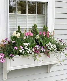 a window box filled with lots of flowers