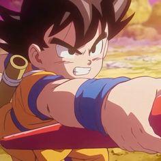 the young gohan is aiming at something with his right hand and pointing it towards the camera