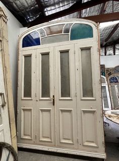 an old white double door in a room