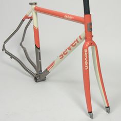 an orange and white bicycle frame with the words severi on it's front end