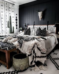 a black and white bedroom with an animal head on the wall