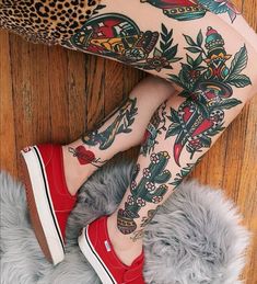 a woman with tattoos and red shoes on