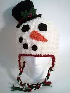 a crocheted snowman hat on top of a white mannequin head