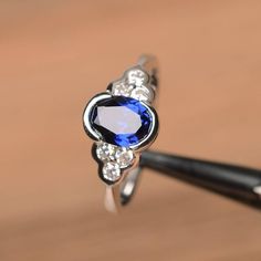 It is a lab sapphire ring. The main stone is 6 mm*8 mm oval cut.weight about 1.75 carats.The basic metal is sterling silver and plated with rhodium.To change the metal to a solid gold (white/rose) or platinum is also available, please ask for a quotation if you want.You can also go to my shop Home for more elegant rings: https://www.etsy.com/shop/godjewelry?ref=hdr_shop_menu Sapphire is the September birthstone.More sapphire rings:https://www.etsy.com/shop/godjewelry?section_id=20715031Customiza Elegant Rings, Blue Gemstone Ring, Oval Sapphire Ring, Swiss Blue Topaz Ring, Blue Gemstone Rings, Silver Engagement Ring, Sapphire Rings, Engagement Ring For Women, London Blue Topaz Ring