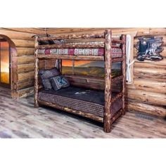 there is a bunk bed in the room with wood walls and flooring on it