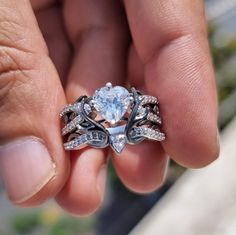 a person holding an engagement ring in their hand