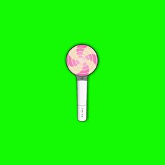 a pink and white lollipop on a green background