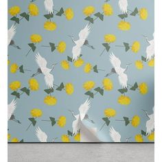 a wall with yellow flowers and white birds on the blue background is featured in this photo