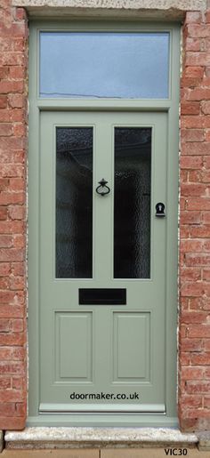 a green front door on a brick building