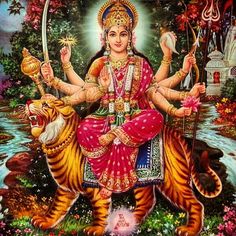 the hindu goddess sitting on top of a tiger