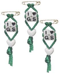 three pieces of green and white string with hearts on them, one has the word i love g s