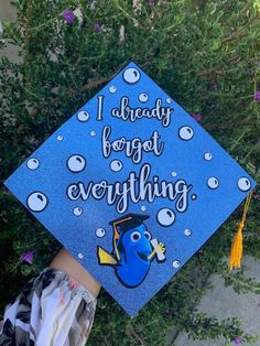 a blue graduation cap with the words i already forgot everything on it and an image of a fish