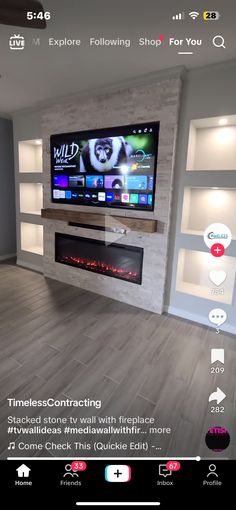 an image of a living room setting with fireplace and flat screen tv on the wall