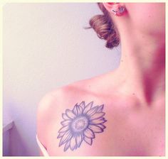 a woman with a sunflower tattoo on her shoulder