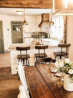 a wooden table sitting in the middle of a kitchen