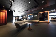 the interior of a car showroom with modern furniture