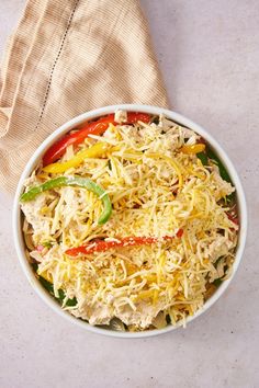 a white bowl filled with pasta and vegetables