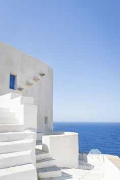 the stairs lead up to an ocean side building