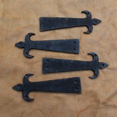 four black iron handles on a wooden surface