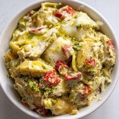 a white bowl filled with food on top of a table