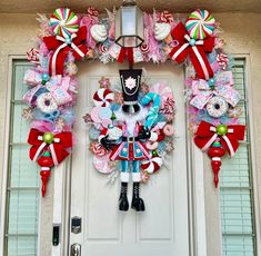 a decorated wreath on the front door of a house