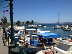 many boats are docked in the water near each other