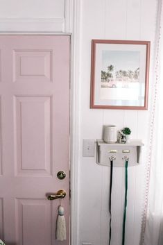 a pink door in the corner of a room