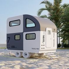 a small trailer is parked on the beach